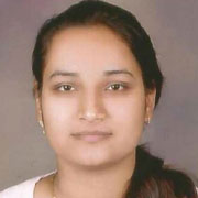 A professional close-up portrait of a woman with dark hair, wearing a simple necklace, and a neutral expression.